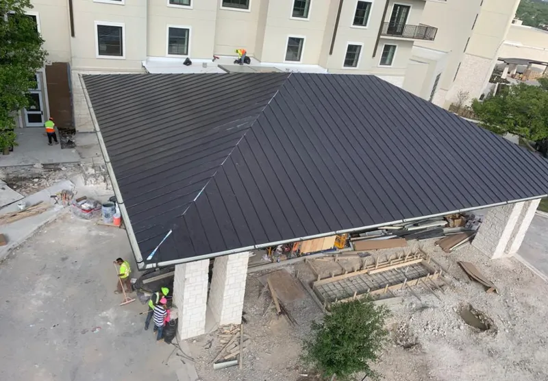 Metal roofing installation team working on a commercial building in Wailea
